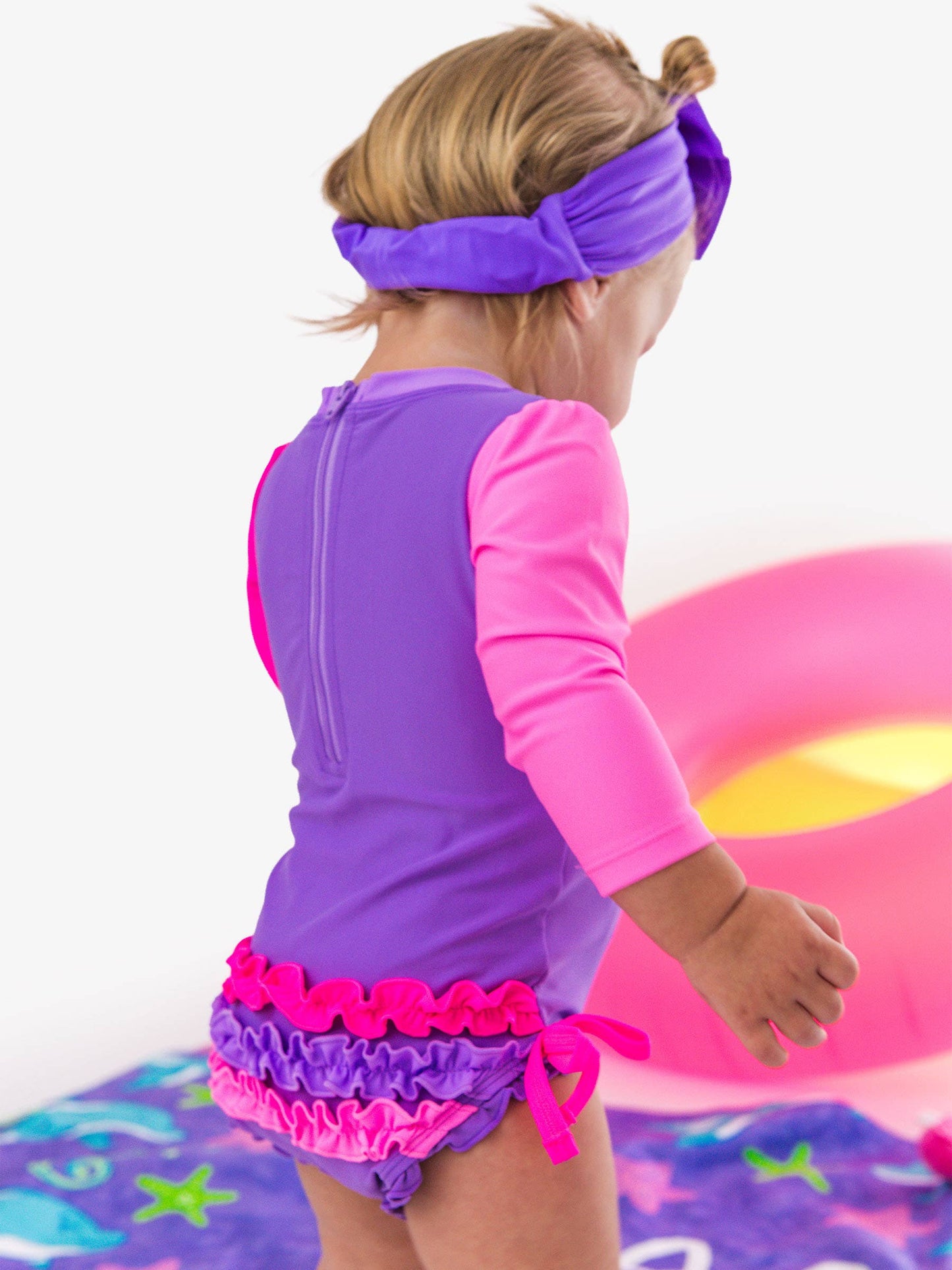 RuffleButts + RuggedButts - Baby Girls Neon Purple Color Block Long Sleeve One Piece Rash Guard Swimsuit with Signature Rear Ruffles: Purple