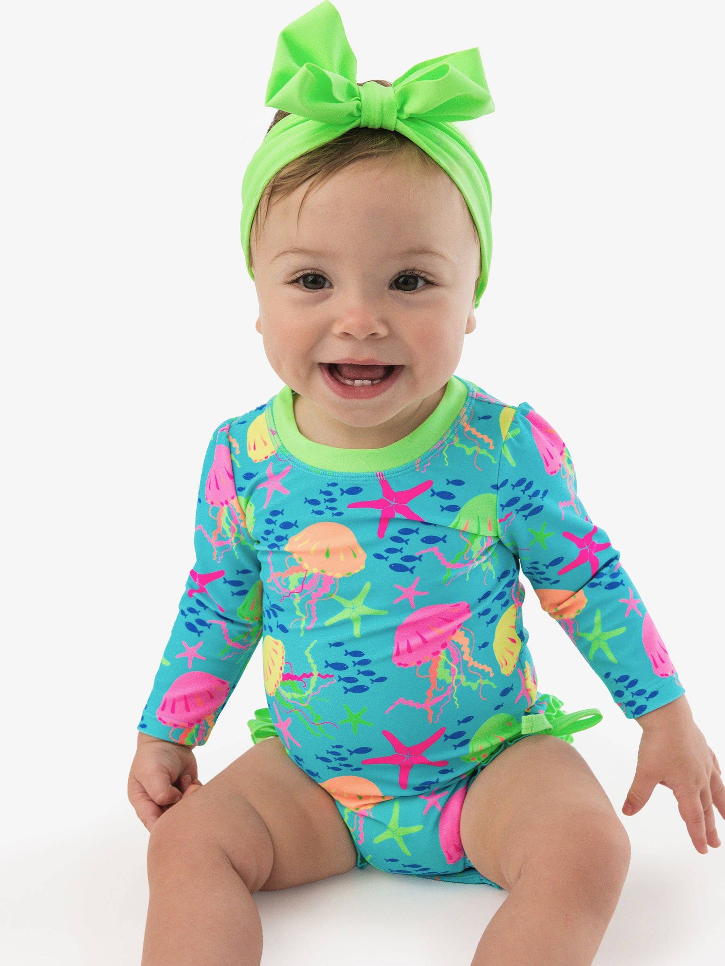 RuffleButts + RuggedButts - Baby Girls Neon Jelly Time Long Sleeve One Piece Rash Guard Swimsuit with Signature Rear Ruffles: Blue