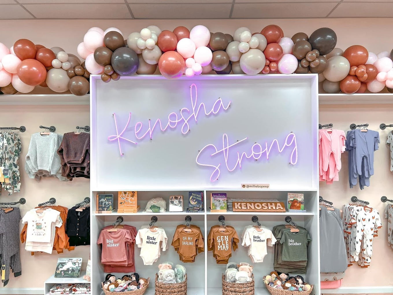 Photo of store interior and 'Kenosha Strong" neon light