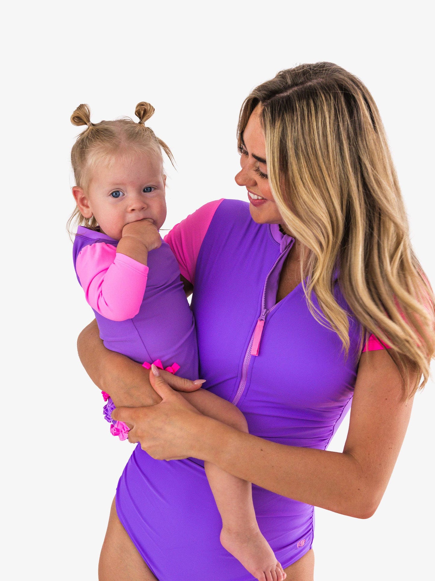 RuffleButts + RuggedButts - Baby Girls Neon Purple Color Block Long Sleeve One Piece Rash Guard Swimsuit with Signature Rear Ruffles: Purple
