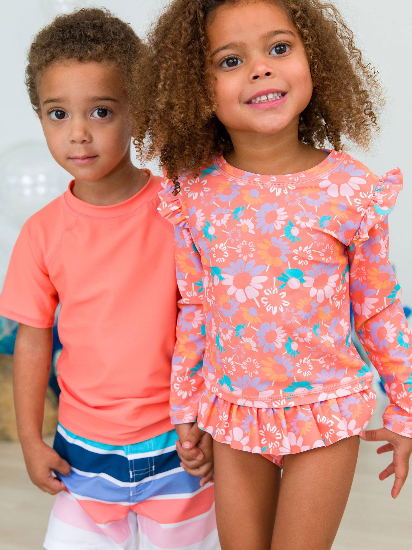 RuffleButts + RuggedButts - Girls Coral Floral Flutter Long Sleeve Rash Guard Skirted 2-Piece Swimsuit: Orange