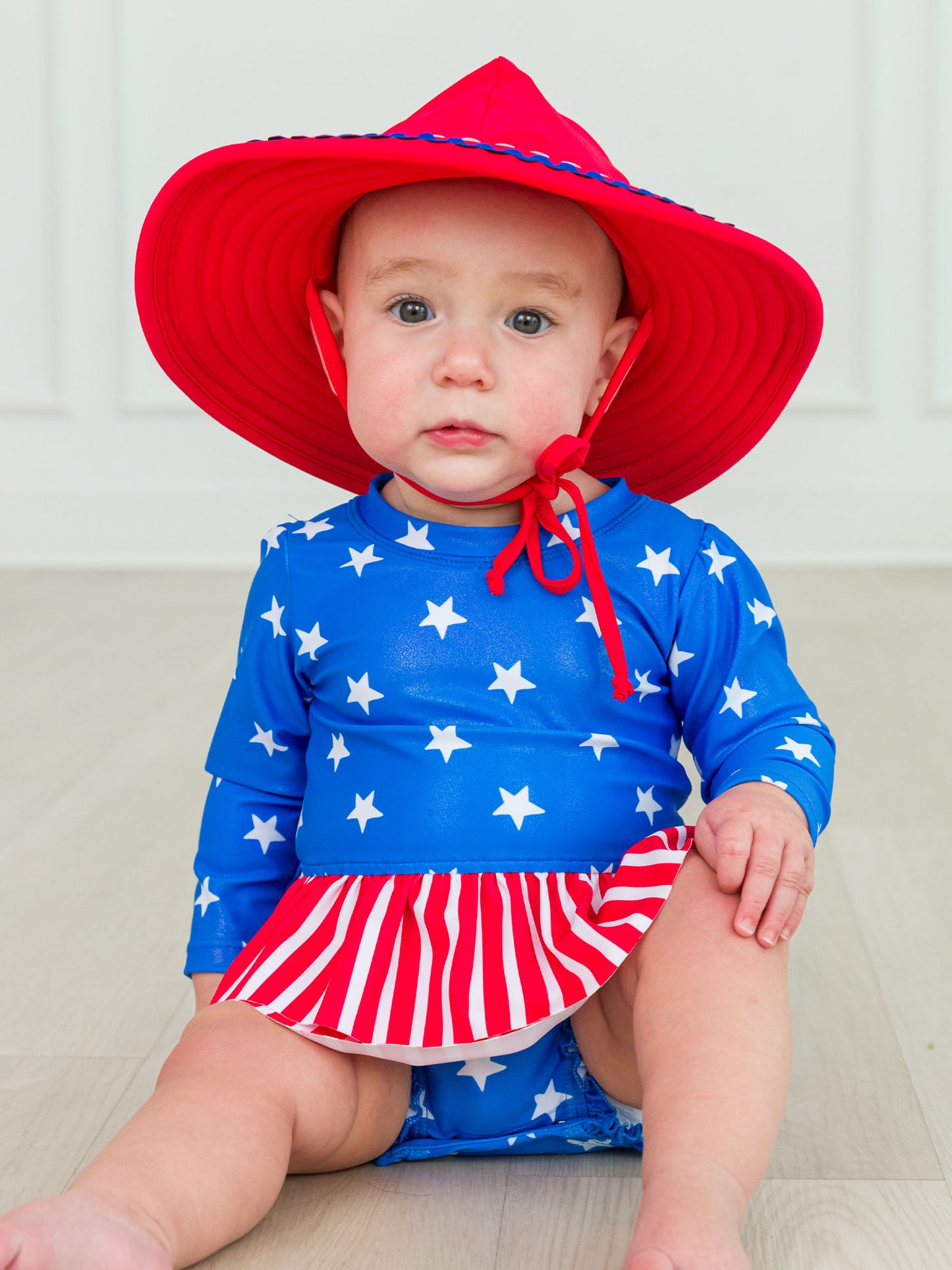 Rufflebutts - Shimmer Stars + Stripes Long Sleeve Skirted One Piece Rash Guard